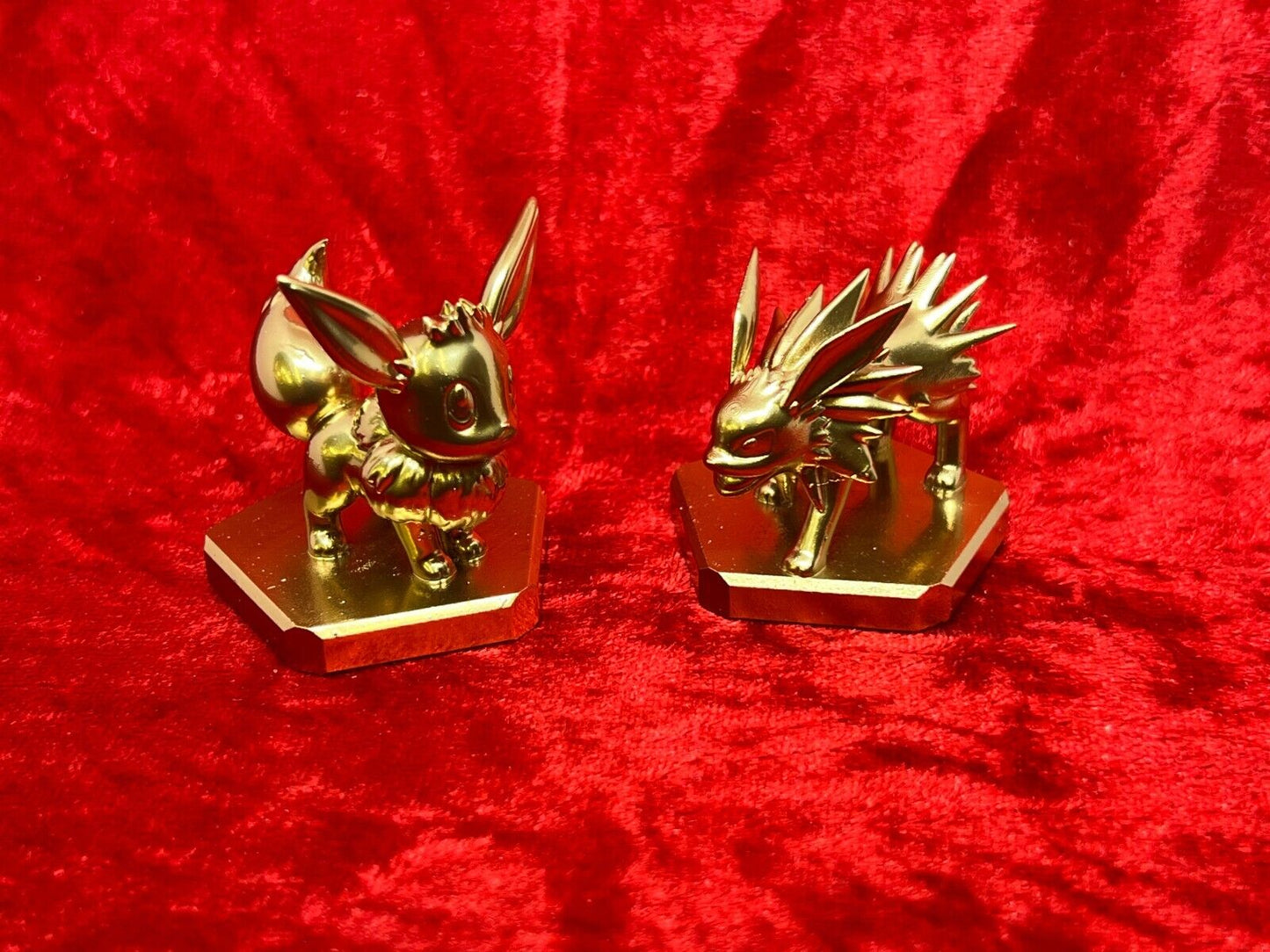 Pokemon #133 Eevee and #135 Jolteon figure Gold TCG Statue