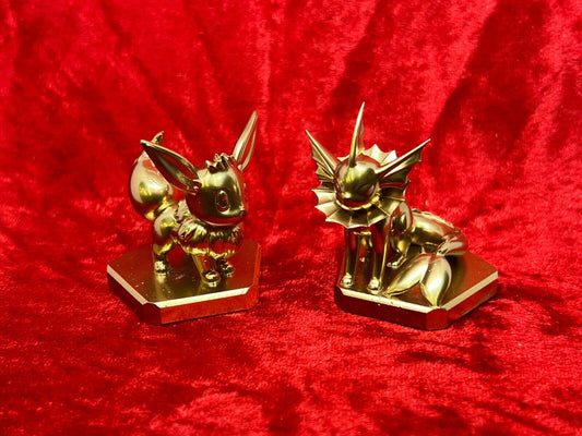 Pokemon #133 Eevee and #134 Vaporeon figure Gold TCG Statue